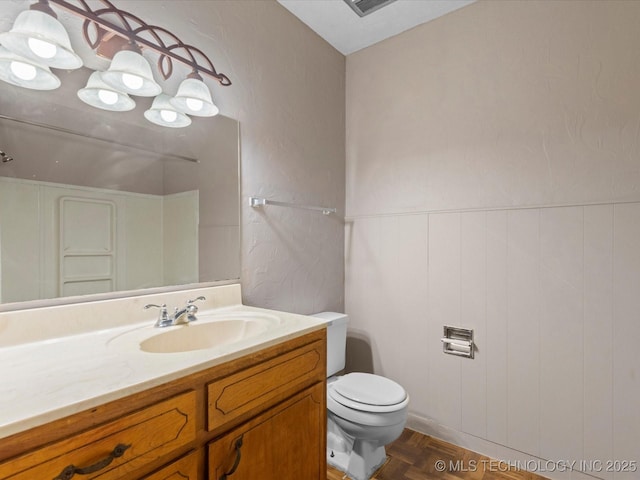 1921 S Santa Fe Pl, Bartlesville, OK 74003 - bathroom with vanity and a wainscoted wall