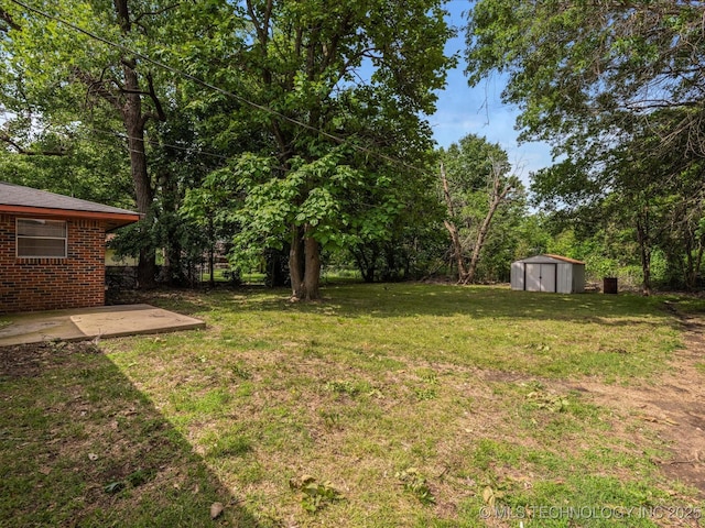 1921 S Santa Fe Pl, Bartlesville, OK 74003 - view of green lawn featuring a storage shed and a patio area