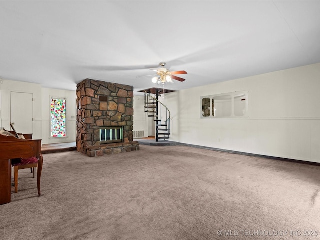 512 W 20th, Bartlesville, OK 74003 - unfurnished living room with carpet flooring, stairway, a ceiling fan, and a stone fireplace