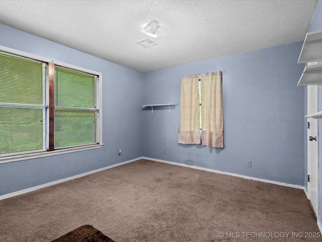 512 W 20th, Bartlesville, OK 74003 - empty room featuring carpet flooring, a textured ceiling, and baseboards