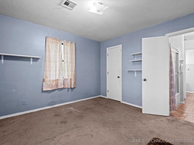 512 W 20th, Bartlesville, OK 74003 - unfurnished bedroom with carpet floors, a textured ceiling, and baseboards