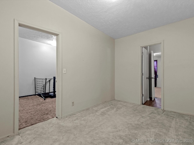 512 W 20th, Bartlesville, OK 74003 - unfurnished room featuring carpet floors and a textured ceiling