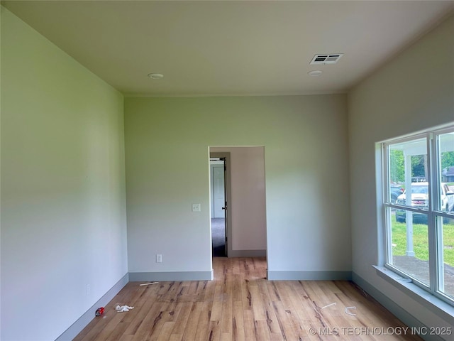 305 E Hickory Ave, Fort Gibson, OK 74434 - empty room with plenty of natural light, light wood finished floors, and baseboards