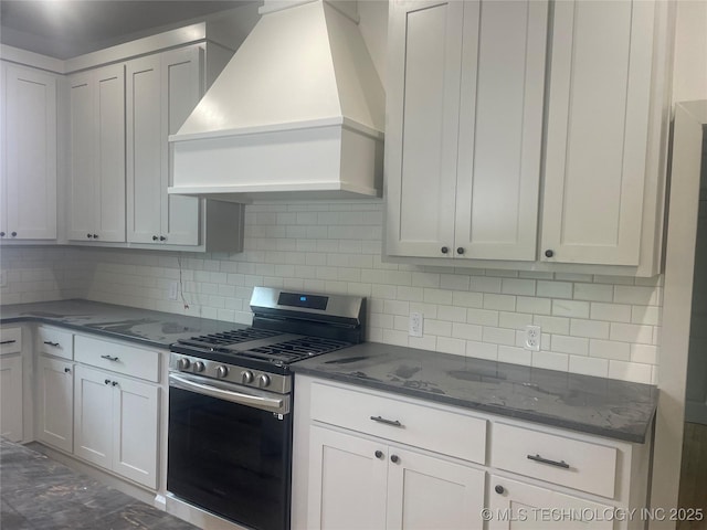 305 E Hickory Ave, Fort Gibson, OK 74434 - kitchen with stainless steel gas range oven, custom range hood, backsplash, dark stone countertops, and white cabinets