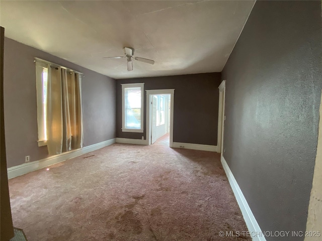 1501 E Okmulgee St, Muskogee, OK 74403 - spare room featuring ceiling fan, carpet, and baseboards