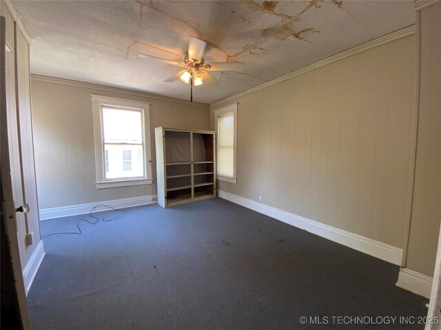 1501 E Okmulgee St, Muskogee, OK 74403 - unfurnished room with dark colored carpet, ceiling fan, baseboards, and crown molding