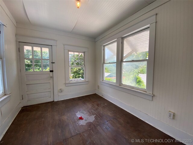 1501 E Okmulgee St, Muskogee, OK 74403 - doorway to outside with dark wood-style flooring, baseboards, and wood walls