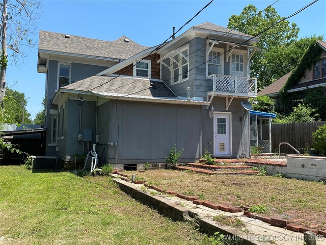 1501 E Okmulgee St, Muskogee, OK 74403 - rear view of property with a shingled roof and cooling unit