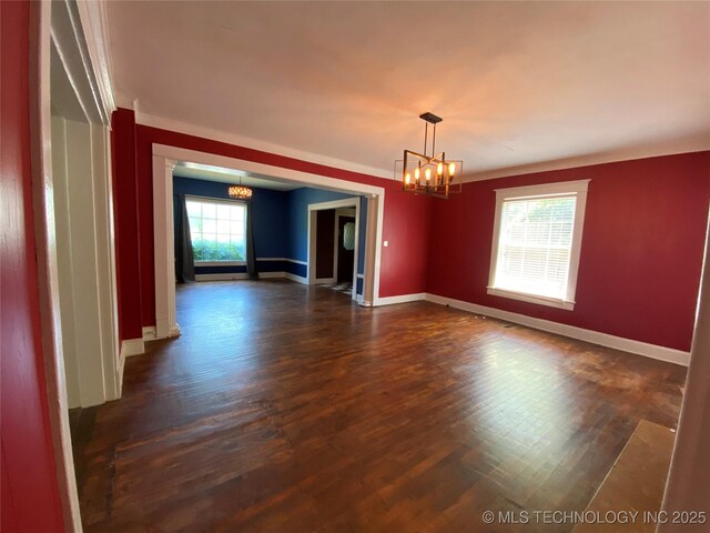 1501 E Okmulgee St, Muskogee, OK 74403 - empty room featuring a chandelier, dark wood-style floors, baseboards, and crown molding