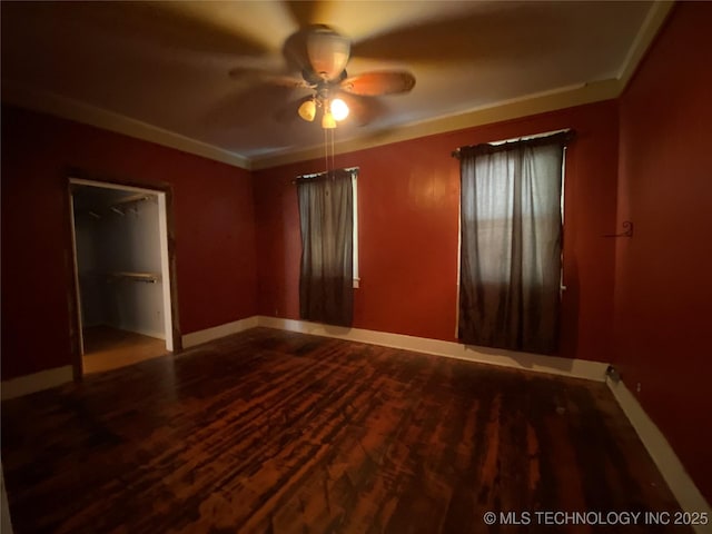 1501 E Okmulgee St, Muskogee, OK 74403 - unfurnished bedroom featuring wood finished floors, baseboards, and a ceiling fan