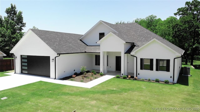 1223 Buckingham, Ardmore, OK 73401 - view of front of property featuring concrete driveway, a garage, a shingled roof, and a front yard