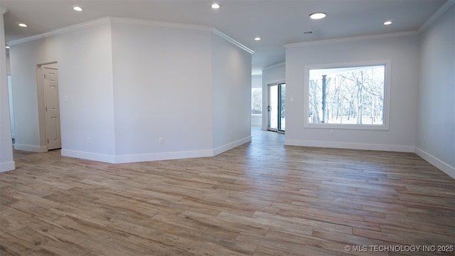 1223 Buckingham, Ardmore, OK 73401 - unfurnished living room featuring light wood-type flooring, crown molding, baseboards, and recessed lighting