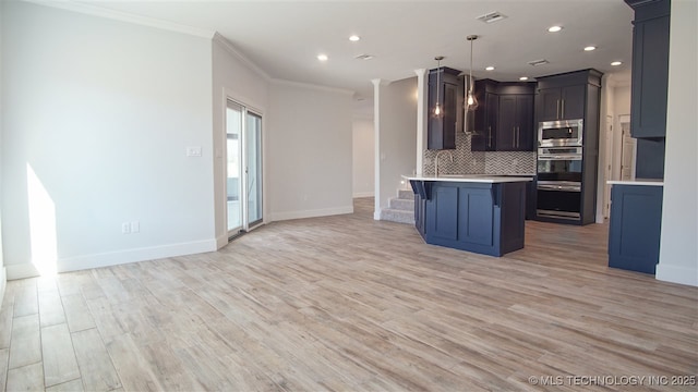 1223 Buckingham, Ardmore, OK 73401 - kitchen with stainless steel appliances, ornamental molding, backsplash, open floor plan, and baseboards