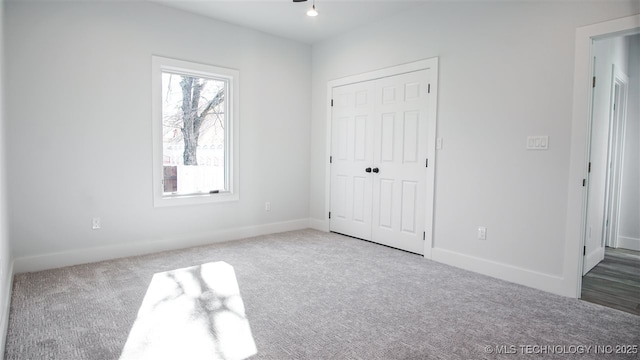 1223 Buckingham, Ardmore, OK 73401 - unfurnished bedroom with carpet flooring, baseboards, and a closet