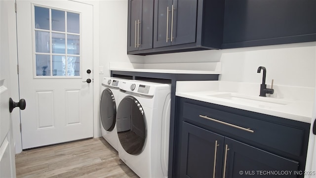 1223 Buckingham, Ardmore, OK 73401 - laundry room featuring separate washer and dryer, cabinet space, and light wood-type flooring