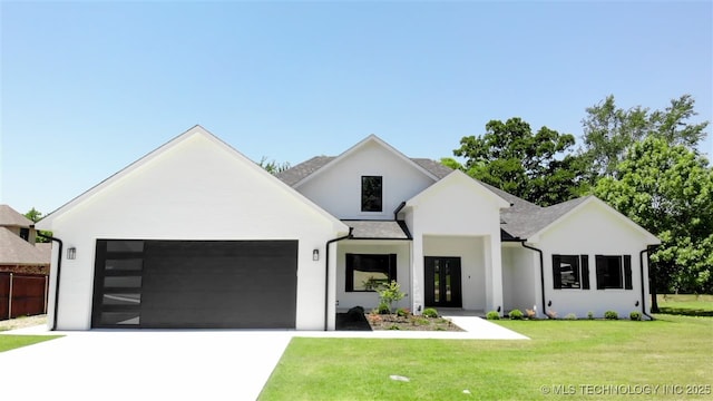 1223 Buckingham, Ardmore, OK 73401 - modern farmhouse with an attached garage, driveway, a front yard, and stucco siding