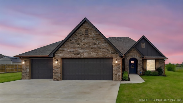 2621 S Catalayah Ln, Claremore, OK 74019 - view of front of property featuring an attached garage, driveway, brick siding, board and batten siding, and a shingled roof