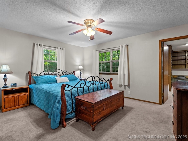 1800 SE Polaris Dr, Bartlesville, OK 74006 - carpeted bedroom featuring a ceiling fan and a textured ceiling