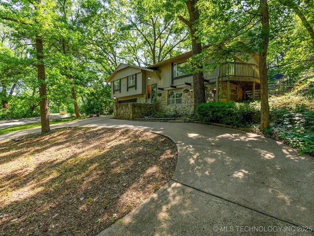 1800 SE Polaris Dr, Bartlesville, OK 74006 - raised ranch with stone siding and board and batten siding