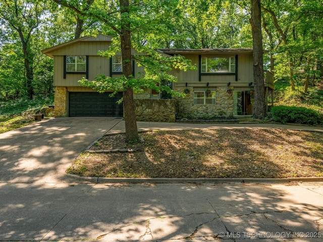 1800 SE Polaris Dr, Bartlesville, OK 74006 - view of front of home featuring stone siding, concrete driveway, and a garage