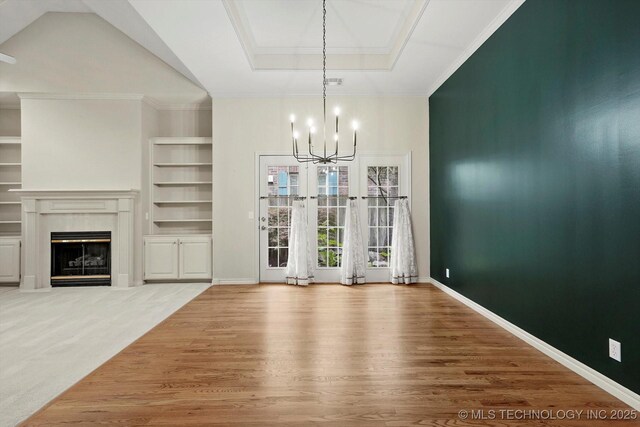 9926 S 79th E Ave, Tulsa, OK 74133 - unfurnished dining area featuring a chandelier, a fireplace, built in shelves, wood finished floors, and baseboards