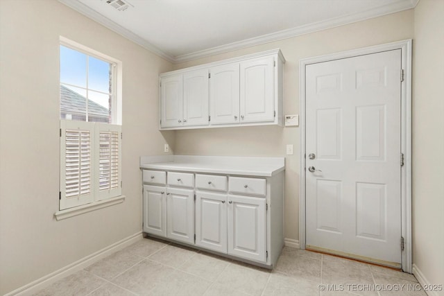 9926 S 79th E Ave, Tulsa, OK 74133 - laundry room featuring baseboards, ornamental molding, and light tile patterned floors