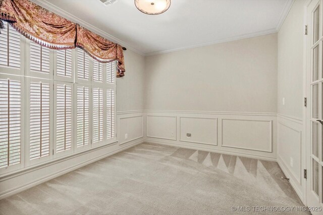 9926 S 79th E Ave, Tulsa, OK 74133 - unfurnished room featuring light carpet, crown molding, wainscoting, and a decorative wall