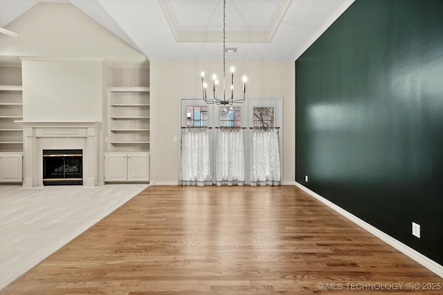 9926 S 79th E Ave, Tulsa, OK 74133 - unfurnished dining area featuring a chandelier, built in shelves, wood finished floors, a fireplace, and baseboards