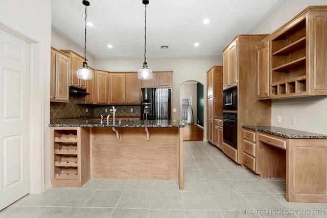 9926 S 79th E Ave, Tulsa, OK 74133 - kitchen with black appliances, open shelves, arched walkways, under cabinet range hood, and a breakfast bar area
