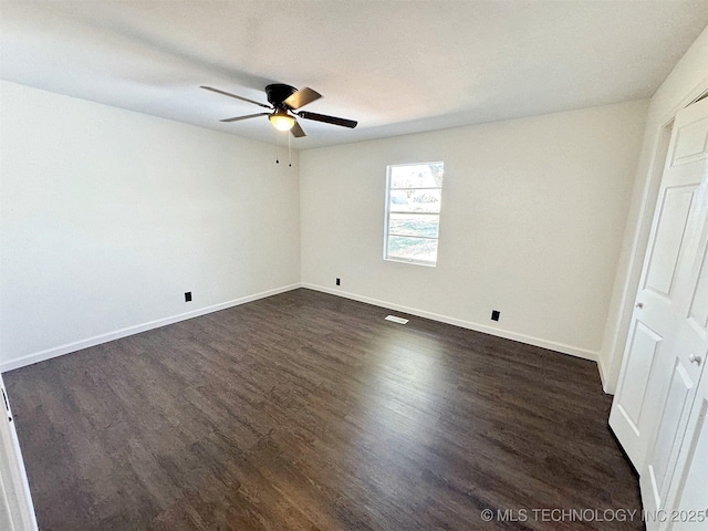 26037 S 520th Rd, Park Hill, OK 74451 - unfurnished bedroom with dark wood-style flooring, baseboards, and a ceiling fan