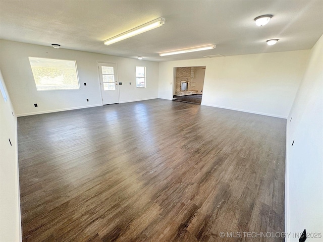 26037 S 520th Rd, Park Hill, OK 74451 - unfurnished living room featuring dark wood-style floors and baseboards