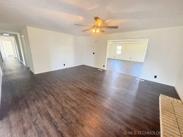 26037 S 520th Rd, Park Hill, OK 74451 - spare room featuring dark wood-style floors, a ceiling fan, a textured ceiling, and baseboards