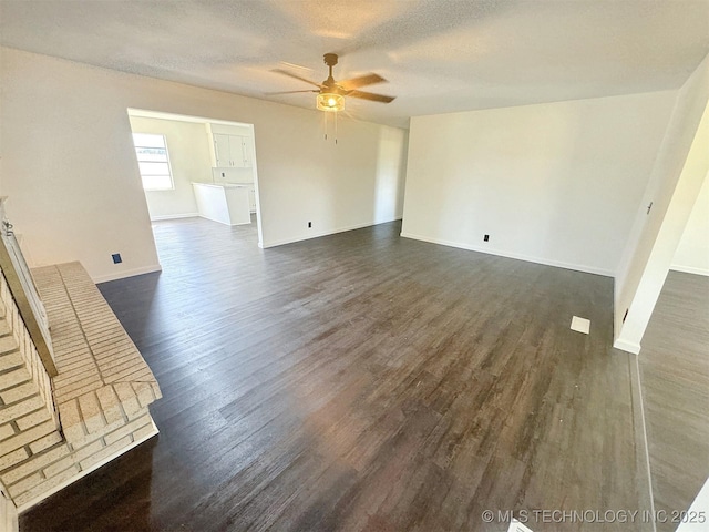 26037 S 520th Rd, Park Hill, OK 74451 - unfurnished living room with ceiling fan, dark wood-type flooring, baseboards, and a textured ceiling