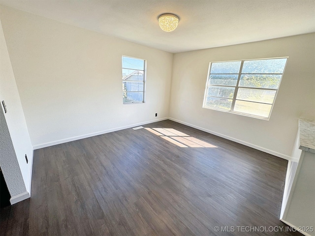 26037 S 520th Rd, Park Hill, OK 74451 - spare room featuring healthy amount of natural light, dark wood-style flooring, and baseboards