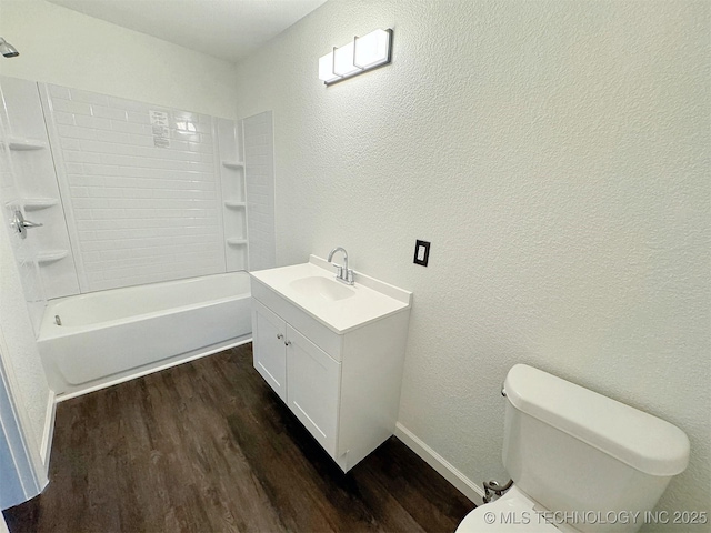 26037 S 520th Rd, Park Hill, OK 74451 - bathroom featuring toilet, wood finished floors, vanity, a textured wall, and washtub / shower combination