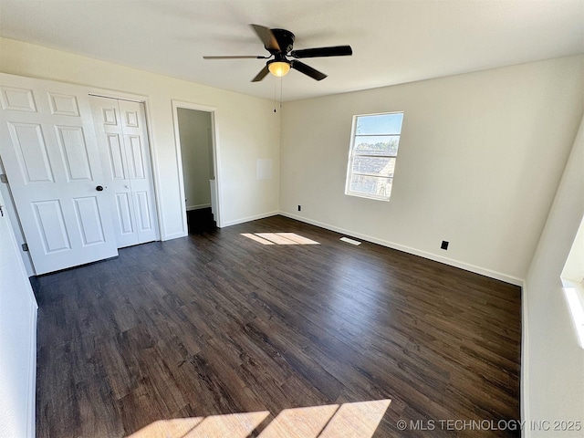26037 S 520th Rd, Park Hill, OK 74451 - unfurnished bedroom featuring dark wood finished floors, baseboards, a closet, and ceiling fan