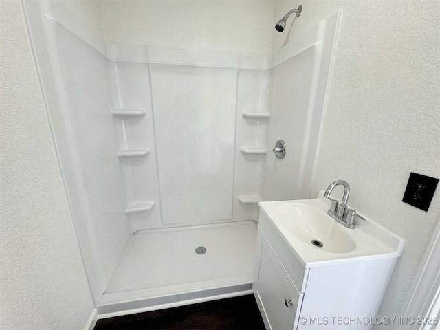 26037 S 520th Rd, Park Hill, OK 74451 - bathroom featuring a textured wall, a shower, and vanity
