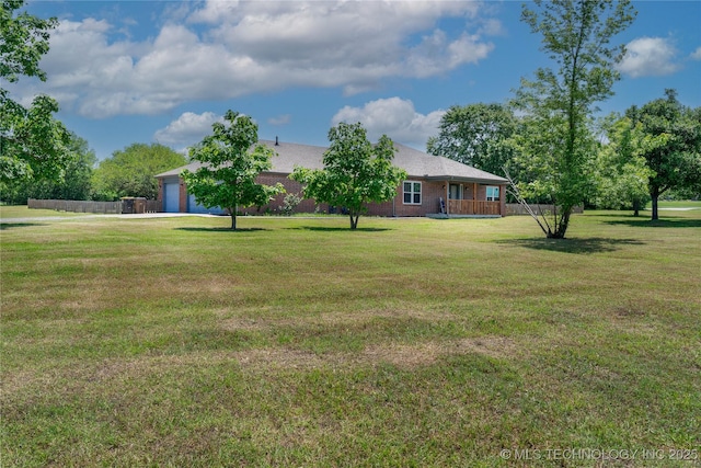 7803 N 71st E Ave, Owasso, OK 74055 - view of green lawn with an attached garage