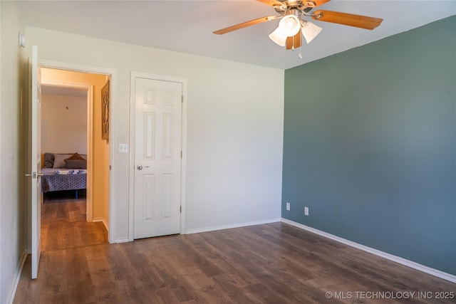 7803 N 71st E Ave, Owasso, OK 74055 - unfurnished bedroom with dark wood finished floors, baseboards, and a ceiling fan