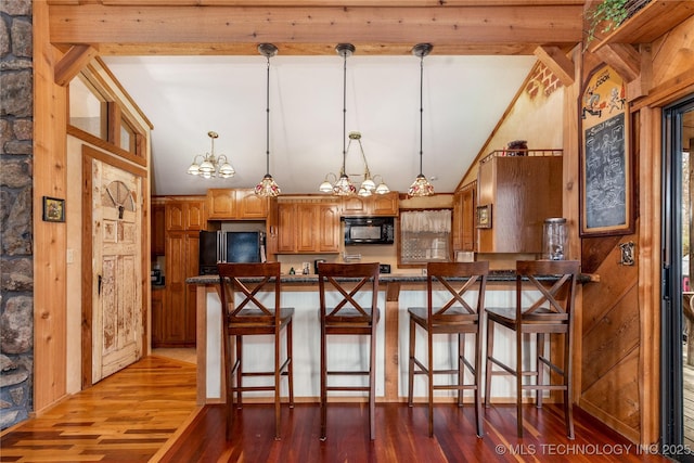 31401 S 620th Rd, Grove, OK 74344 - kitchen featuring black microwave, refrigerator, a peninsula, wood finished floors, and vaulted ceiling