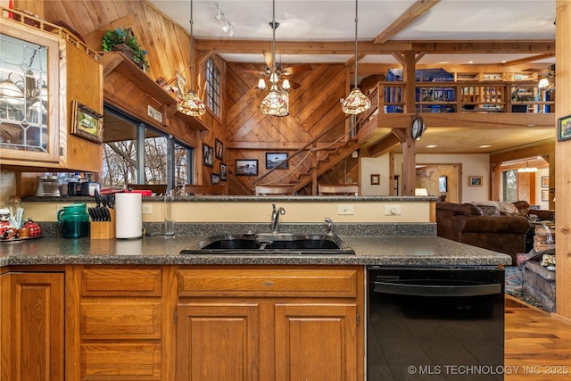31401 S 620th Rd, Grove, OK 74344 - kitchen featuring black dishwasher, a sink, dark countertops, wooden walls, and brown cabinetry