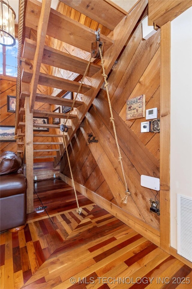 31401 S 620th Rd, Grove, OK 74344 - stairs featuring wood finished floors, wooden walls, and a chandelier