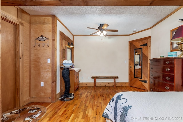 31401 S 620th Rd, Grove, OK 74344 - bedroom with light wood-style flooring, a textured ceiling, crown molding, and baseboards