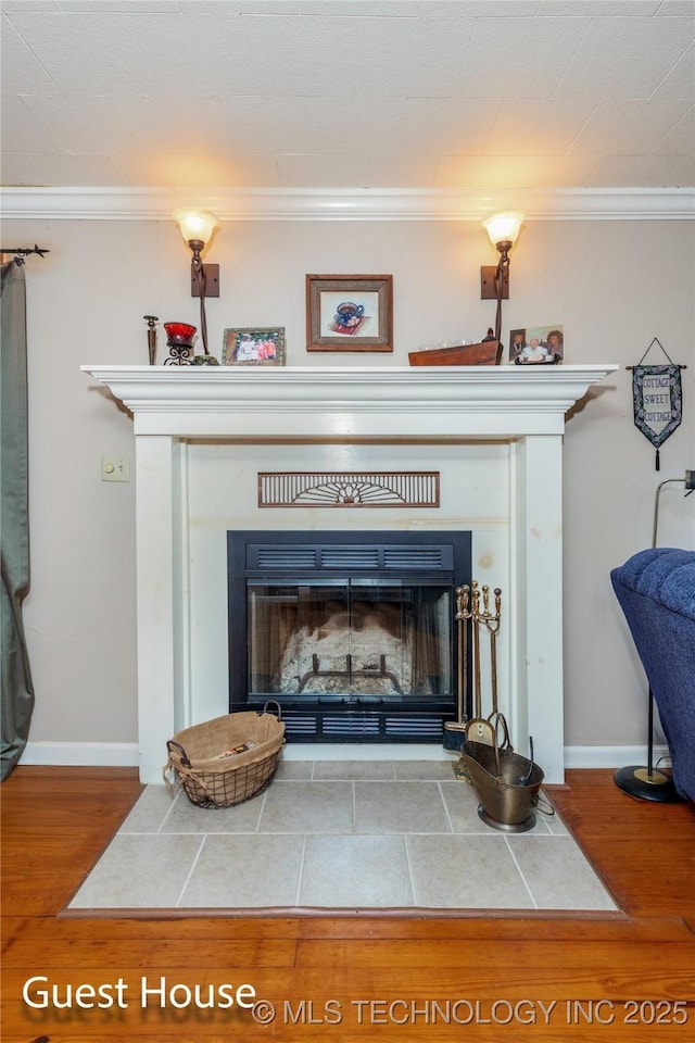 31401 S 620th Rd, Grove, OK 74344 - detailed view of a fireplace with flush hearth, crown molding, wood finished floors, and baseboards