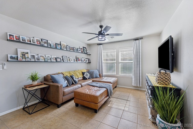 14201 E 101st St, Owasso, OK 74055 - living room featuring ceiling fan, light tile patterned flooring, baseboards, and a textured ceiling