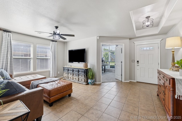 14201 E 101st St, Owasso, OK 74055 - living area featuring baseboards, light tile patterned floors, and a ceiling fan