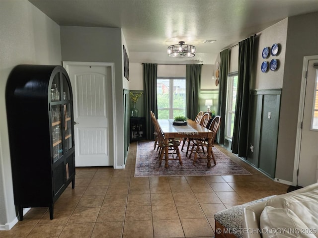 14201 E 101st St, Owasso, OK 74055 - tiled dining area featuring a textured ceiling and baseboards
