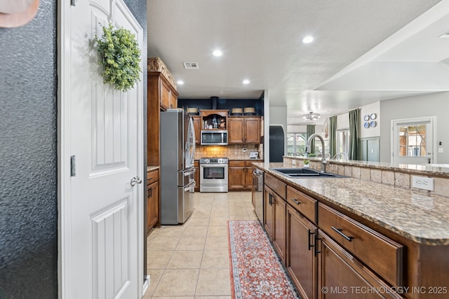 14201 E 101st St, Owasso, OK 74055 - kitchen with stainless steel appliances, a sink, decorative backsplash, open shelves, and recessed lighting