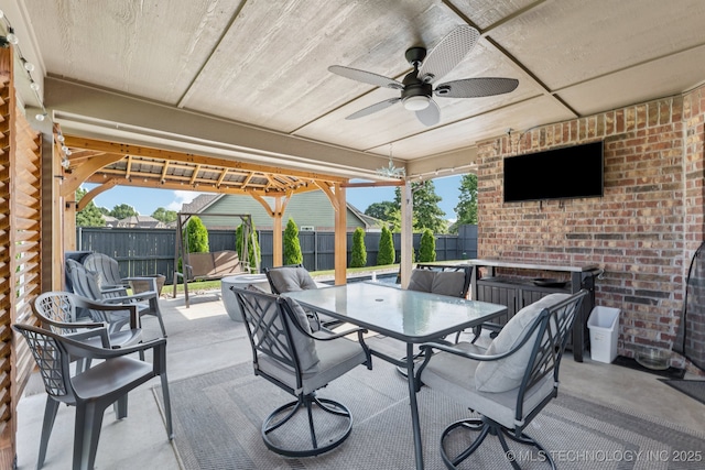 14201 E 101st St, Owasso, OK 74055 - fenced backyard with outdoor dining space, a ceiling fan, and a patio