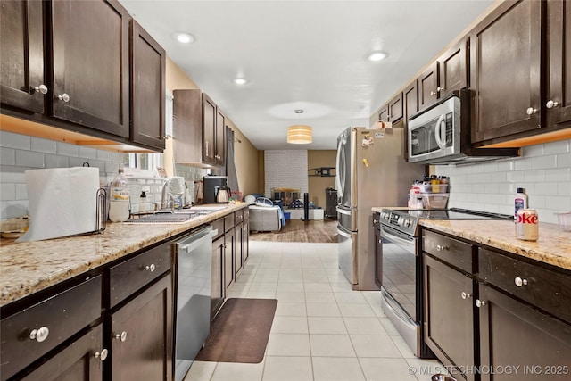 7630 E 54th Pl, Tulsa, OK 74145 - kitchen with appliances with stainless steel finishes, dark brown cabinets, and decorative backsplash